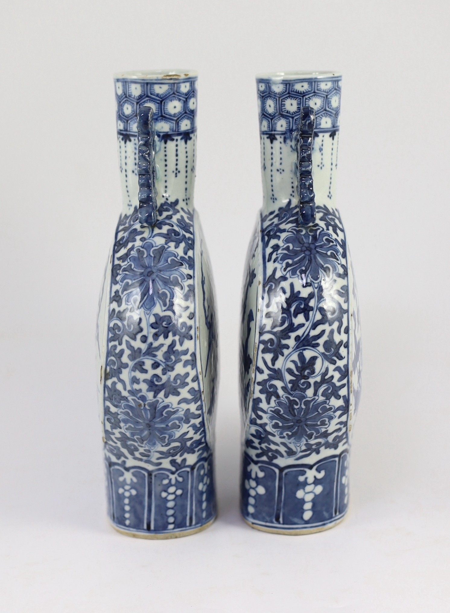 A pair of Chinese blue and white moon flasks, 19th century, 30cm high, small glaze losses and firing cracks